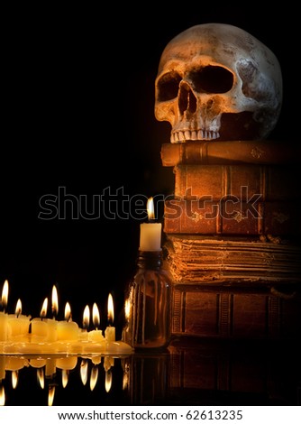 Halloween border with skull, ancient books and candles
