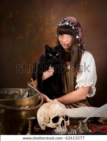 Halloween witch holding her black cat with green eyes (the book is 300 years old, no copyright problems)