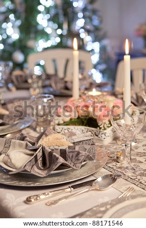 Christmas tree and fancy dinner table with folded napkins