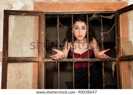 Woman behind bars asking why she is in prison