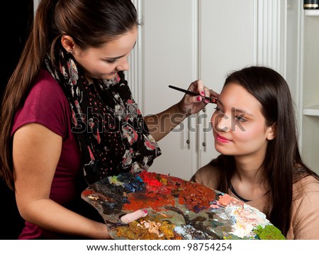Female make-up artist working with a painter's pallet in her hands