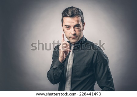 portrait of businessman pointing with his finger
