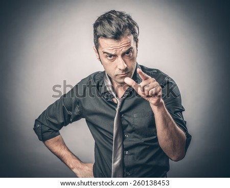 Angry businessman pointing to you