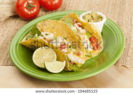 Homemade fresh fish tacos on a green plate