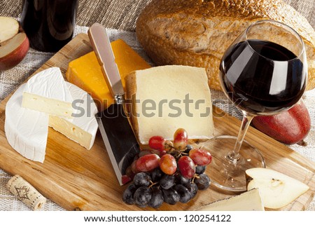 Red Wine And Assorted Cheese Plate with fruit