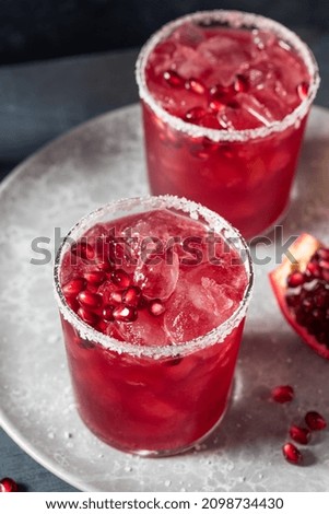 Similar – Image, Stock Photo Glass of pomegranate margarita with flower blooms near near feathers