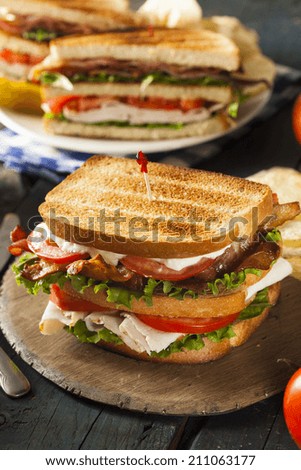 Turkey and Bacon Club Sandwich with Lettuce and Tomato
