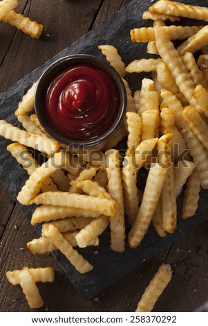 Unhealthy Baked Crinkle French Fries with Ketchup