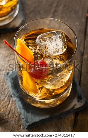Homemade Old Fashioned Cocktail with Cherries and Orange Peel