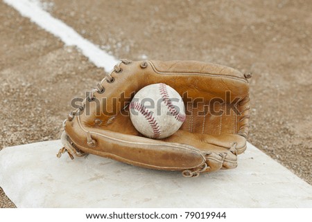 A baseball glove  in a baseball field