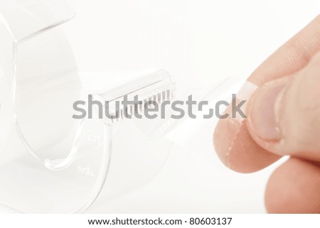 A Clear tape dispenser against a white background