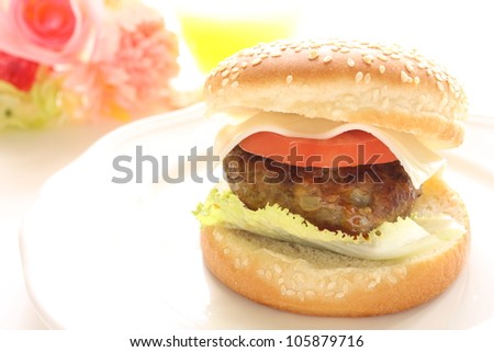 Delicious homemade cheese hamburger with flower with copy space