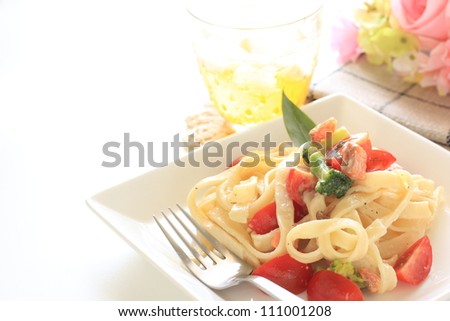 Italian cuisine, cherry tomato and salmon pasta and drink