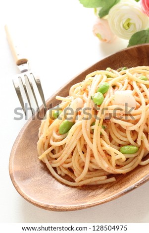 Italian cuisine, edamame and mentaiko pasta on wooden plate with copy space