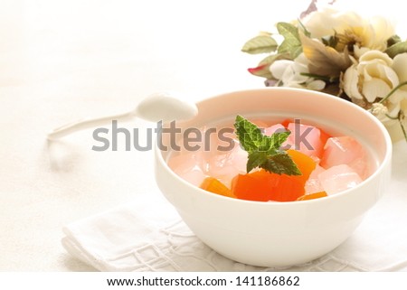 Asian gourmet dessert, peeled mandarin orange on algae jelly for summer food image
