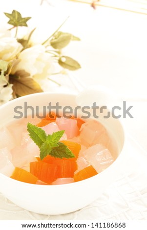 Asian gourmet dessert, peeled mandarin orange on algae jelly for summer food image
