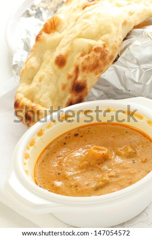 indian seafood curry in plastic container and Naan for take out food image