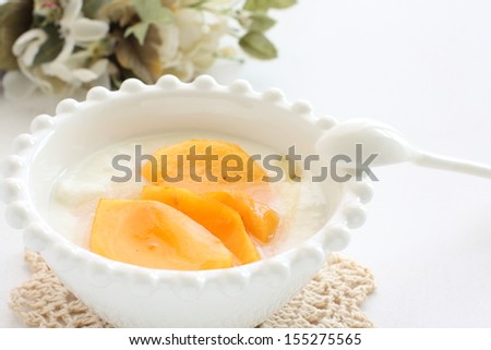freshness cut fruit,  persimmon on honey yogurt for healthy dessert image