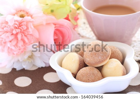 sugar donut and milk tea with flower for afternoon tea image
