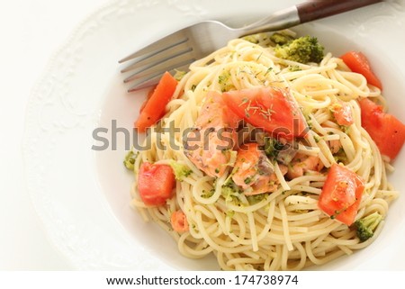 Italian food, salmon and tomato pasta with dried thymus on top