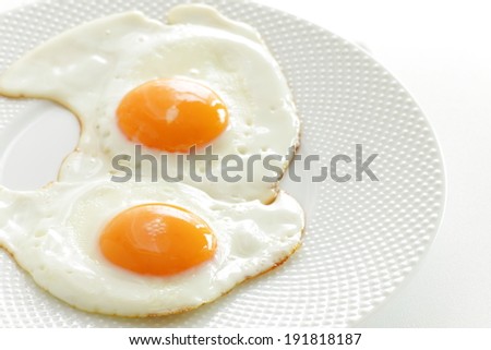 gourmet breakfast, sunny side up egg on white dish