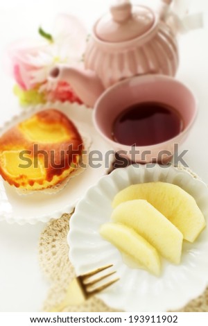 Gourmet dessert, Fuji apple with tea and cake on background for winter food image in Diorama style