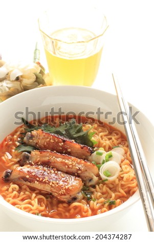 Asian food, spicy chicken wing and noodle with beer on background