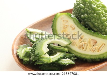 south east asian food ingredient, bitter melon chopped on wooden plate