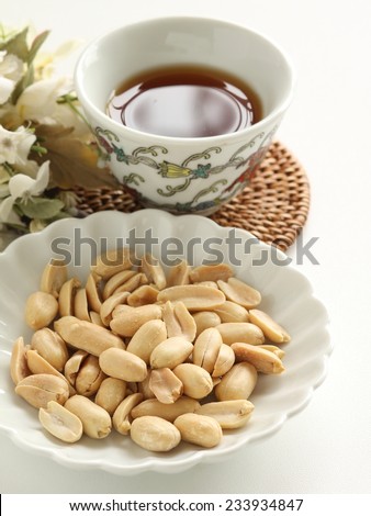 asian snack food, peanut on dish and chinese tea