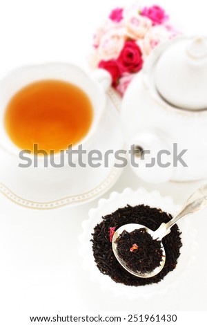 English tea, black tea leaves and rose