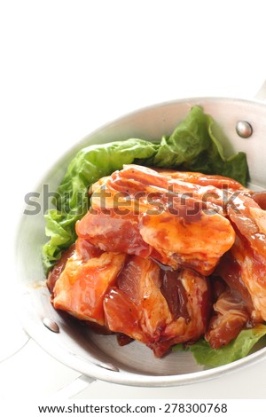 Barbecue cooking, marinated pork sparerib on stainless pan for camping food image