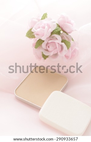 Cosmetic foundation on pink fabric satin