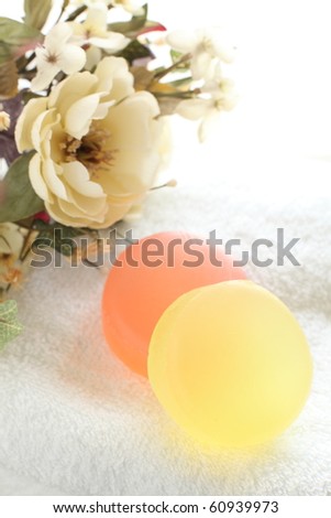 Orange and yellow herb soap with elegant flower for spa image
