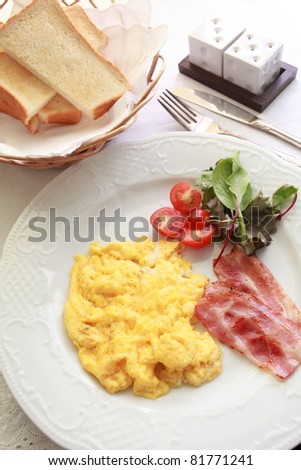 Western breakfast, scrambled egg and bacon with toast