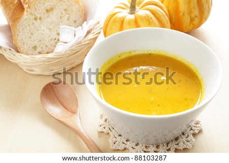 Homemade Pumpkin cream soup served with french bread
