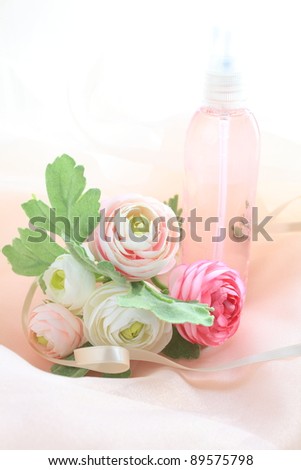 Pink spray bottle and artificial flower for perfume and cosmetic image