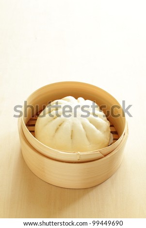 Chinese steamed dumpling, meat bun on bamboo steamer