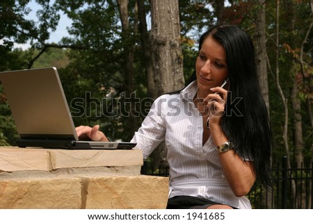 Woman Multi Tasking on Cell Phone and Computer