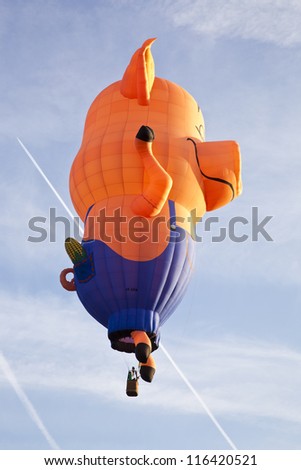 BARNEVELD, THE NETHERLANDS - 17 AUGUST 2012: Colorful pig balloon taking off at international balloon festival Ballonfiesta in Barneveld on August 17 2012 in Barneveld, The Netherlands