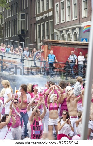 AMSTERDAM - AUGUST 6: People celebrate Gay Pride weekend at Canal Parade in Amsterdam on August 6, 2011. Gay Pride celebrates equality for gay,lesbian and transgender communities