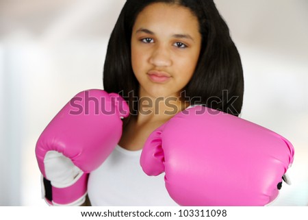 Teen girl with pink boxing gloves on