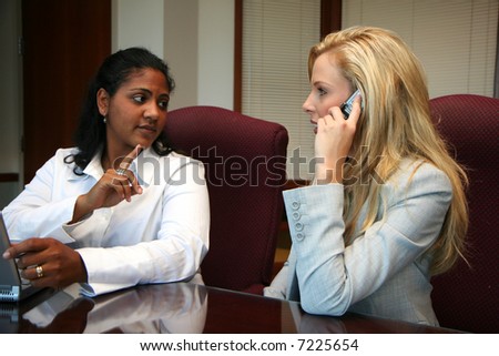 Young businesswoman with coworkers in an office setting