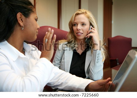 Young caucasian businesswoman with coworkers in an office setting
