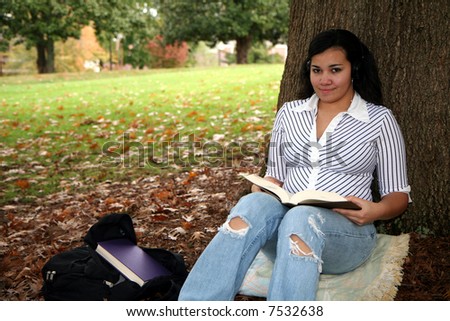 Teenager with studying for a test outside at school