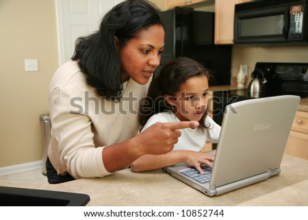 Family in kitchen on the computer