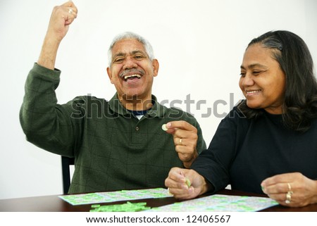 People playing bingo with chips and cards