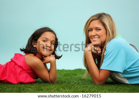 Family Laying Together Outside In The Grass