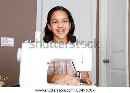 Girl using a sewing machine to make crafts