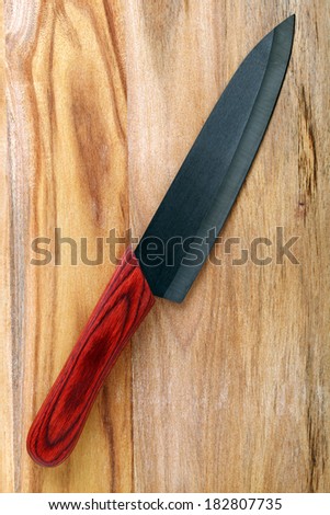 Knife on cutting board on white background