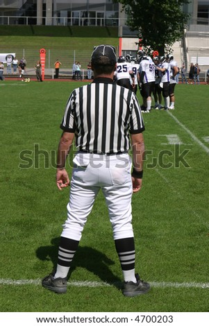 american football referee standing at the sideline